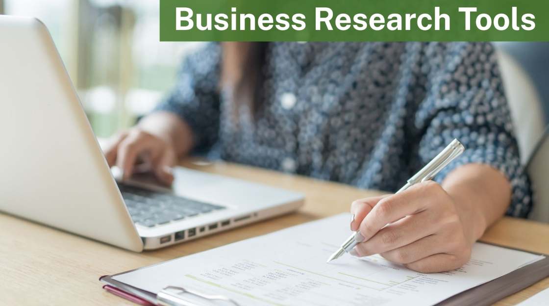 Person sitting at laptop with documents