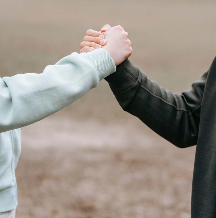 Two people clasping hands 