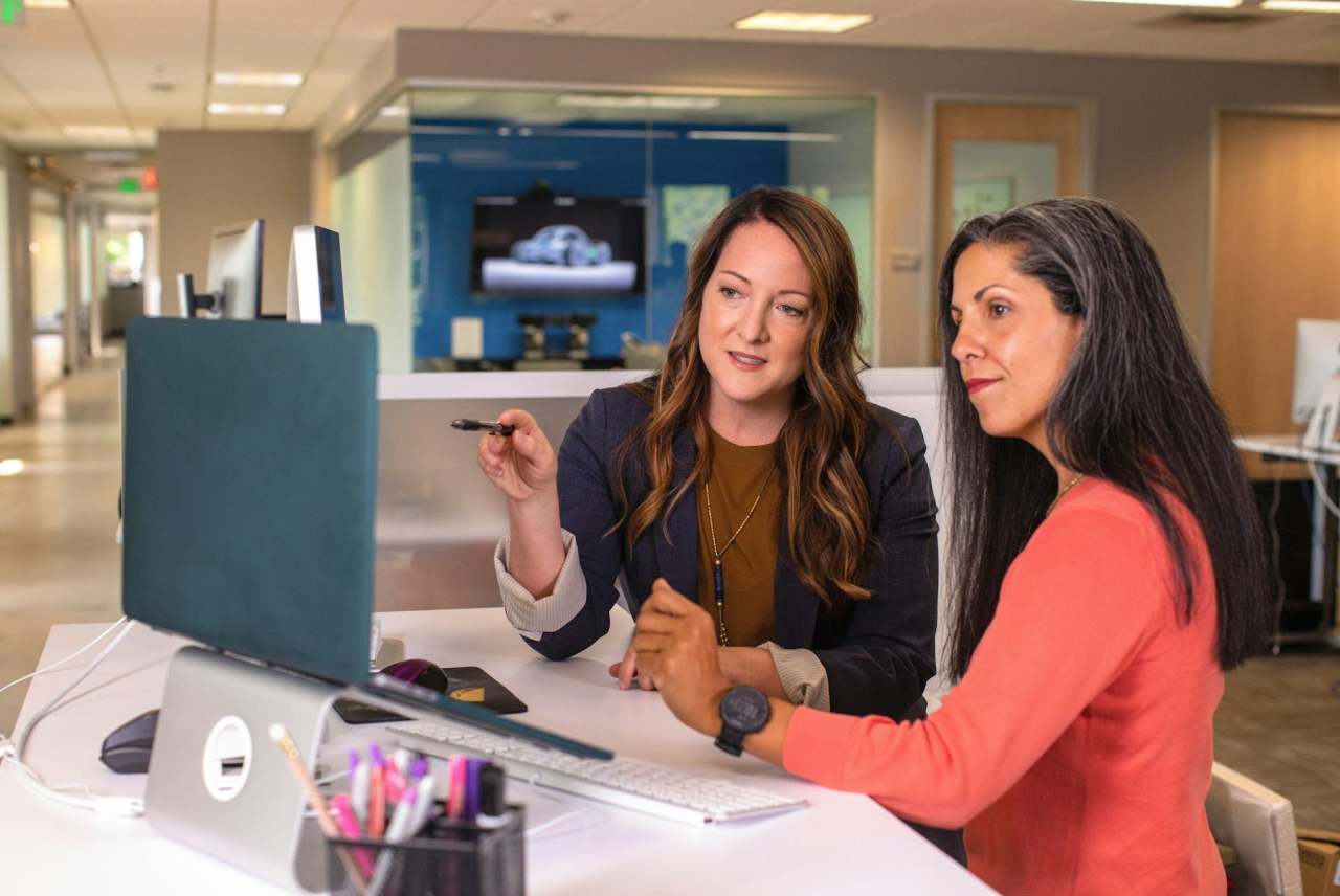 Two women looking at computer in an office