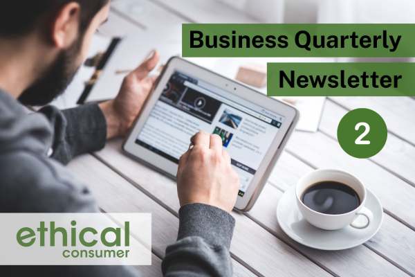 Man sat at table with tablet device and cup of coffee reading 